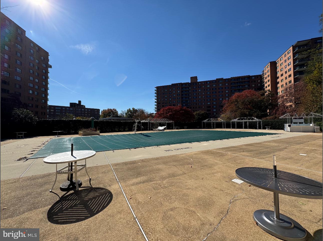 4201 Cathedral Avenue Northwest, Unit 1219E Washington, DC 20016 - Photo 17 of 20 a swimming pool with outdoor seating and yard