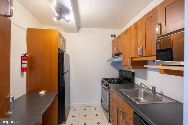 a kitchen with stainless steel appliances granite countertop a stove and a refrigerator