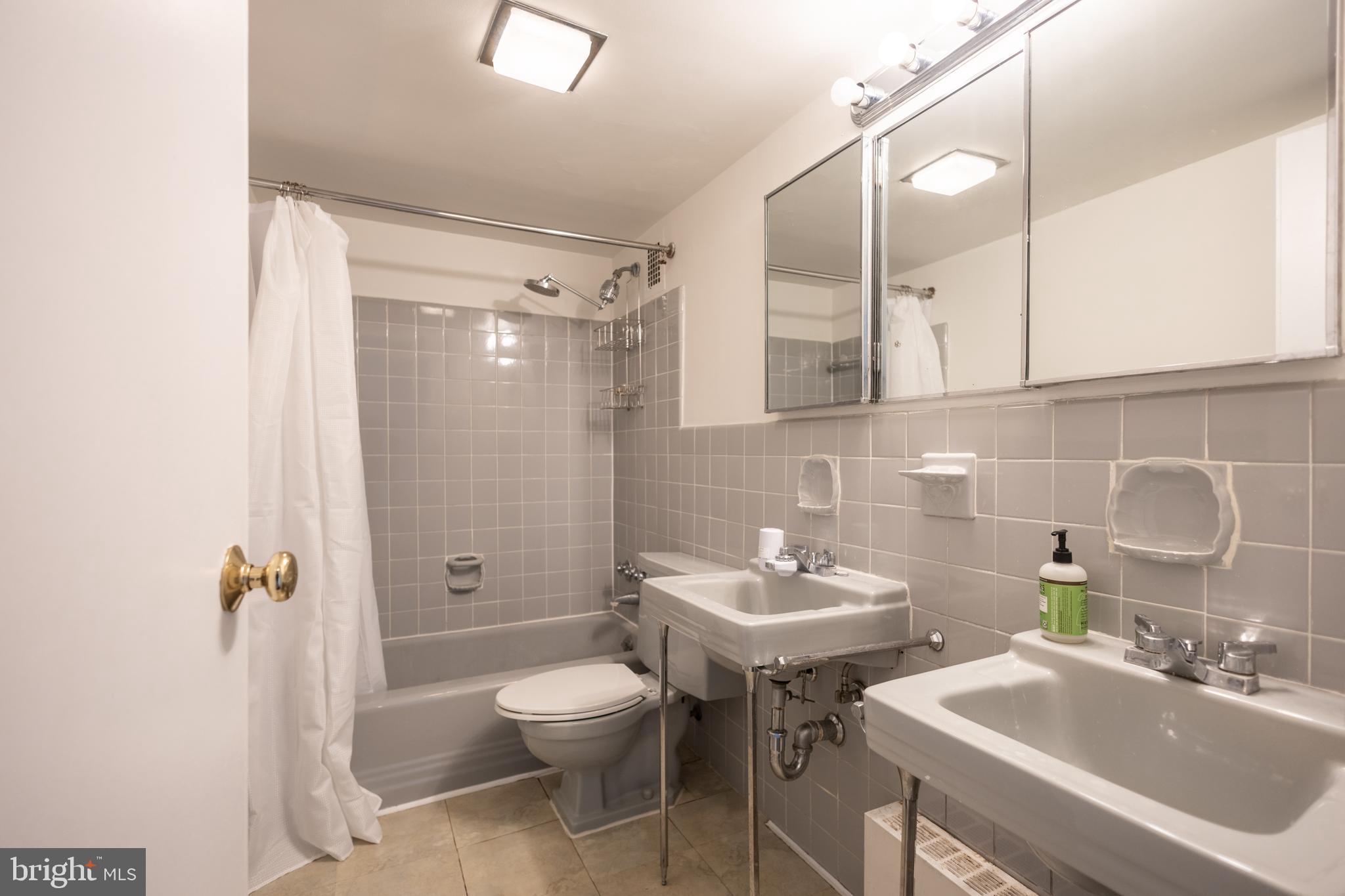 4201 Cathedral Avenue Northwest, Unit 1219E Washington, DC 20016 - Photo 9 of 20 a bathroom with a sink toilet and shower