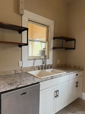 a kitchen with a sink cabinets and window