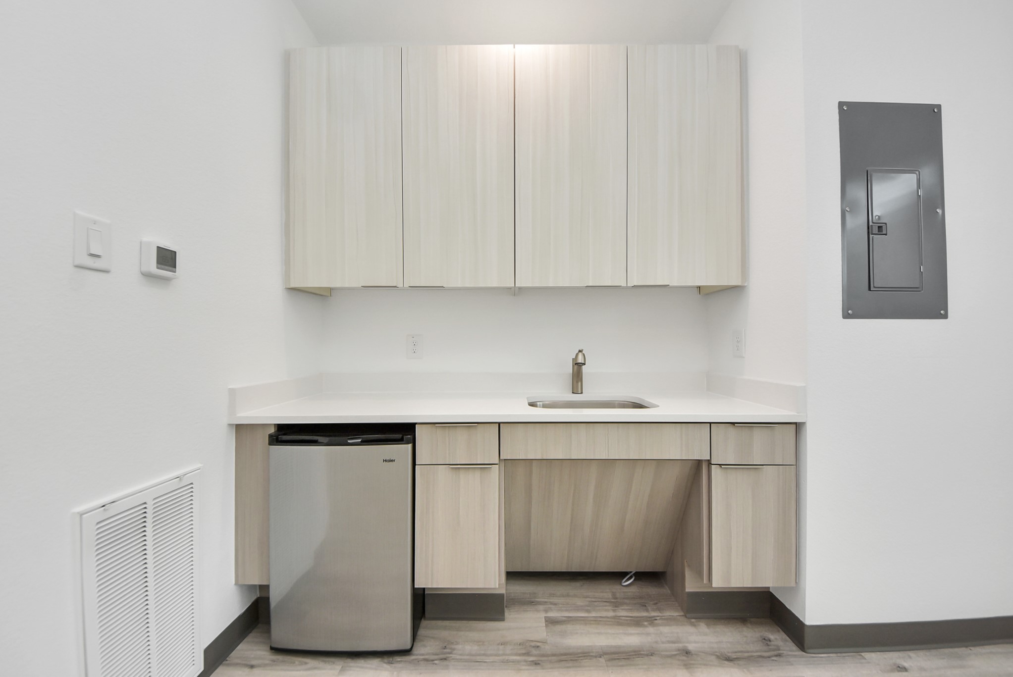 18716 Centro Main Street Conroe, TX 77385 - Photo 4 of 50 Built-in commercial kitchenette with cabinetry, sink, and under-counter refrigerator for staff convenience.