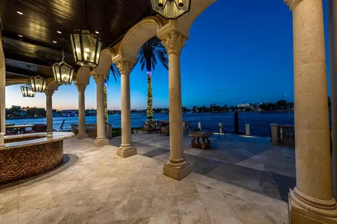a front view of a multi story residential apartment building with yard and sign board