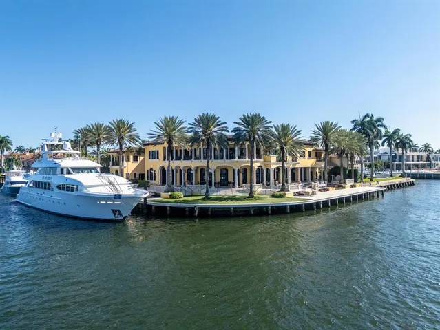 a view of a hallway with furniture and chandelier