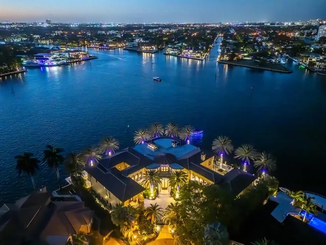 a view of a swimming pool with a lawn chairs under an umbrella