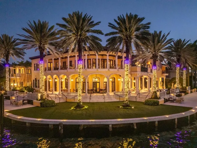 a living room with furniture a chandelier and a large window