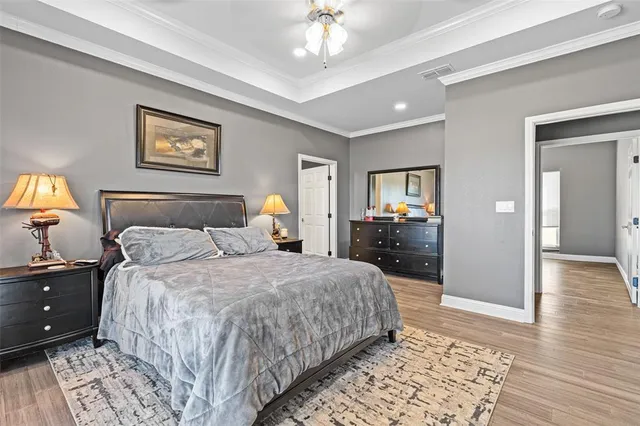 a bedroom with a bed and a chandelier