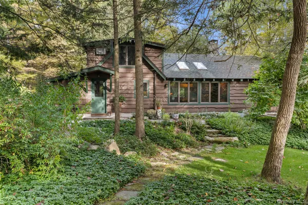 a living room with furniture a fireplace and a floor to ceiling window