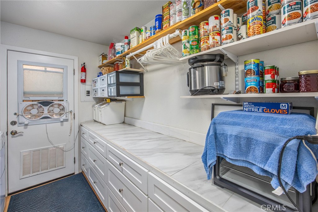 15212 El Centro Road Hesperia, CA 92345 - Photo 48 of 75 Laundry with cabinets and storage for can goods