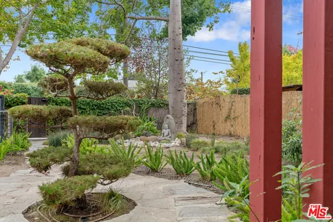 a couple of flower plants in front of door