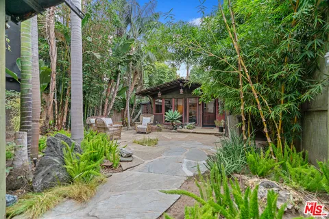 a view of a house with backyard and sitting area
