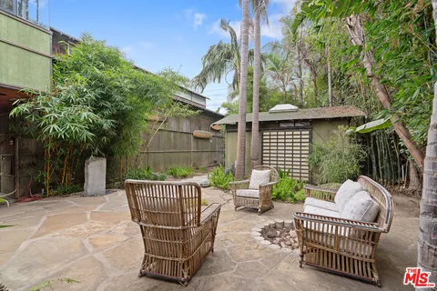a view of a chair and tables in the patio