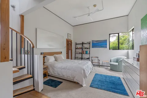 a bedroom with a bed and a couch