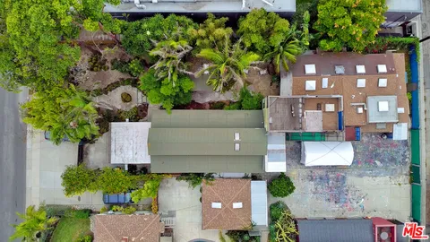 an aerial view of a house with a yard and garden
