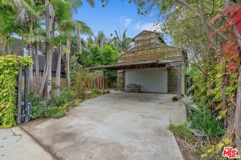 a front view of a house with a yard and tree s