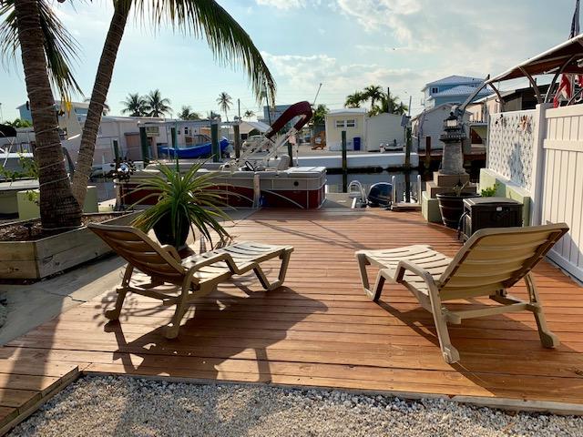 Sun Bathing area next to pool, dock and