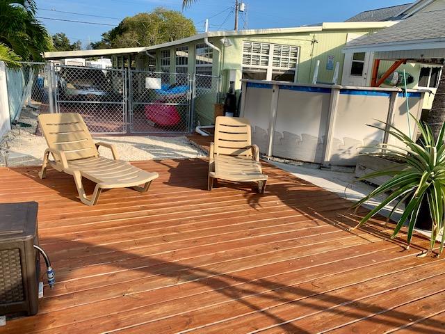 Sun Bathing area next to pool, dock and