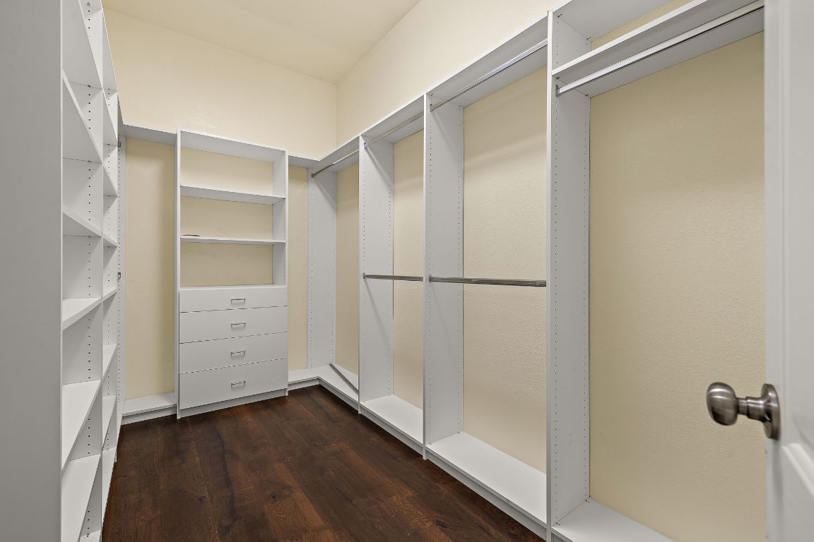 174 Estrella Crossing Georgetown, TX 78628 - Photo 20 of 39 Walk in closet with dark wood-type flooring