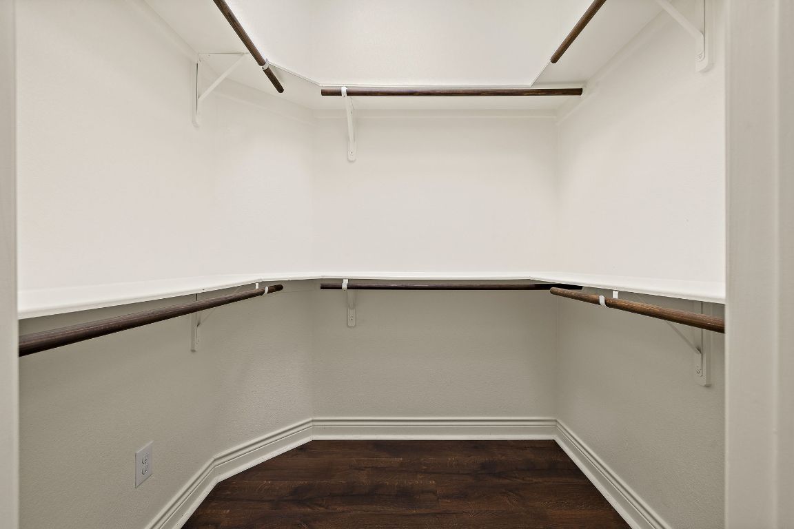 174 Estrella Crossing Georgetown, TX 78628 - Photo 21 of 39 Walk in closet featuring dark wood-type flooring