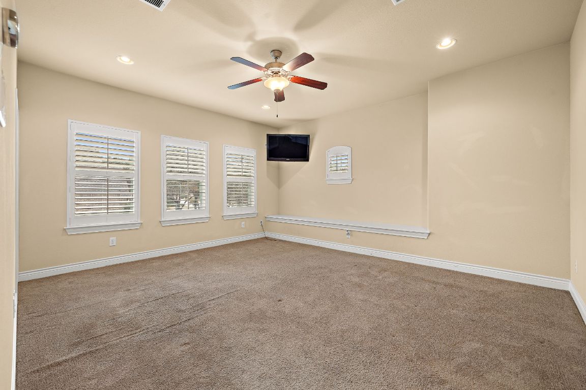 174 Estrella Crossing Georgetown, TX 78628 - Photo 28 of 39 Empty room featuring carpet floors, recessed lighting, and ceiling fan