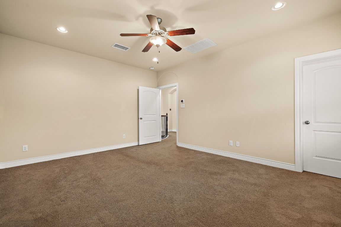 174 Estrella Crossing Georgetown, TX 78628 - Photo 29 of 39 Carpeted empty room featuring recessed lighting and a ceiling fan