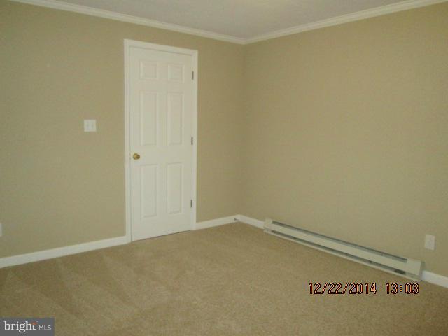 10638 Green Valley Road Union Bridge, MD 21791 - Photo 22 of 22 an empty room with a bench