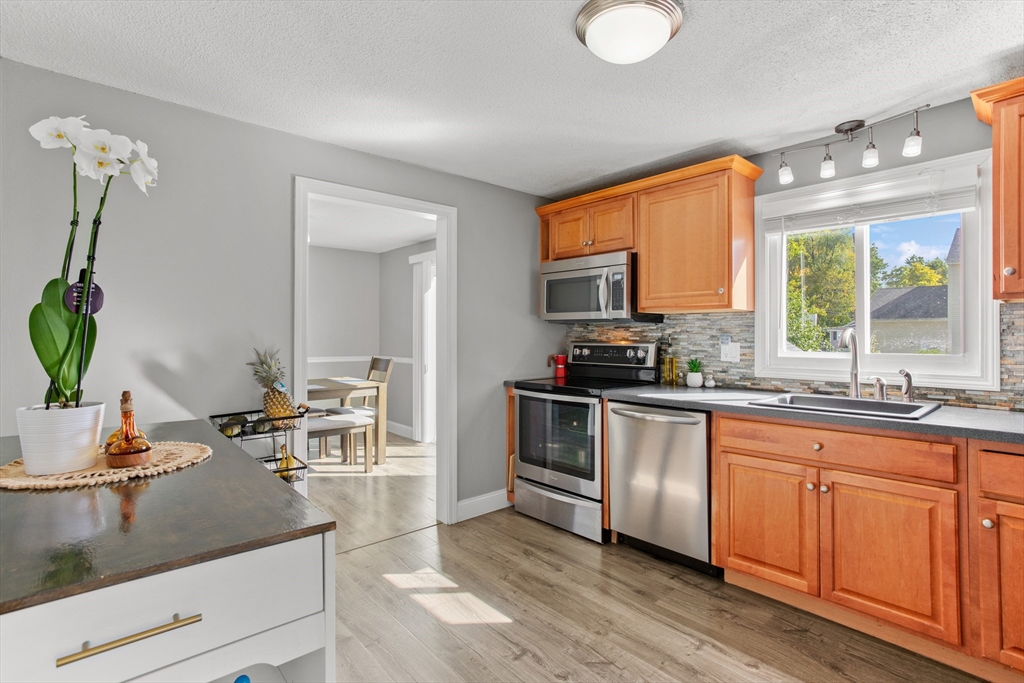 70 Underhill Street Nashua, NH 03060 - Photo 11 of 39 a kitchen with sink stove and cabinets