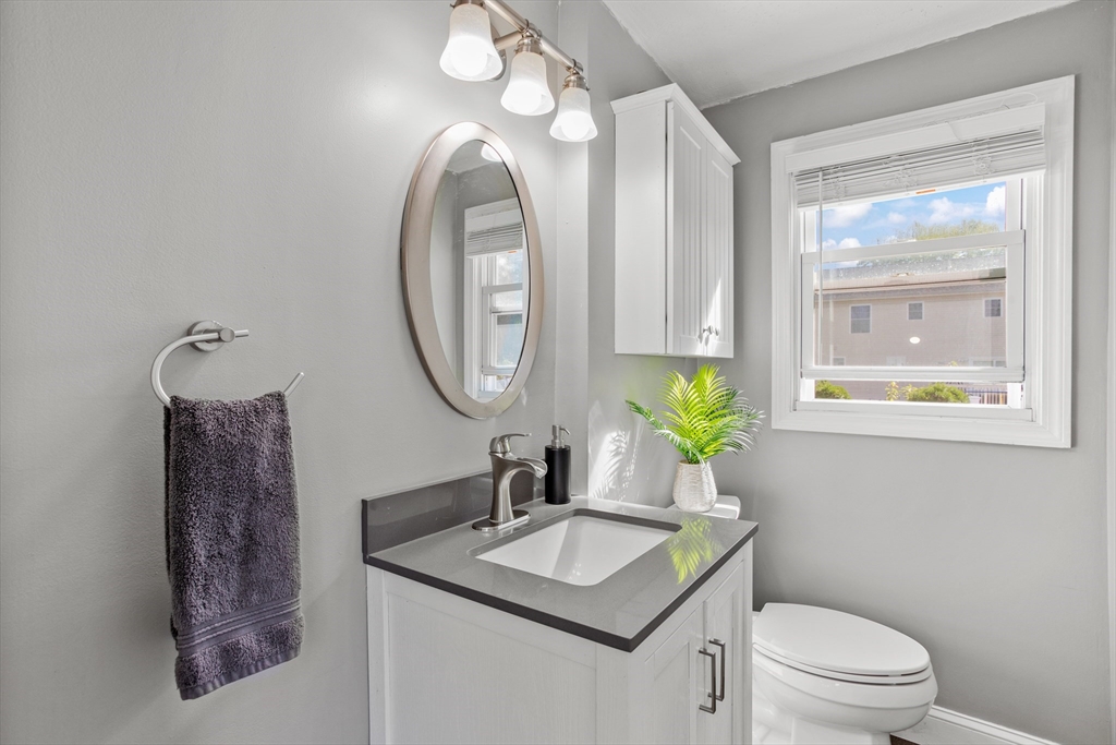 70 Underhill Street Nashua, NH 03060 - Photo 14 of 39 a bathroom with a toilet a sink and a mirror