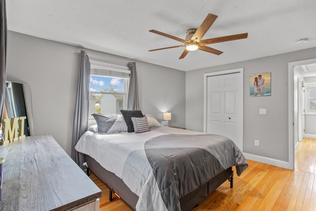 70 Underhill Street Nashua, NH 03060 - Photo 17 of 39 a bedroom with a bed and a chandelier
