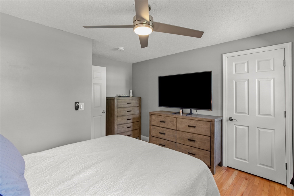 70 Underhill Street Nashua, NH 03060 - Photo 20 of 39 a bedroom with a bed and a flat screen tv