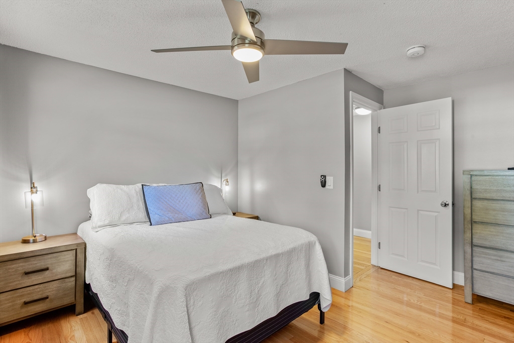 70 Underhill Street Nashua, NH 03060 - Photo 21 of 39 a bedroom with a bed and a chandelier