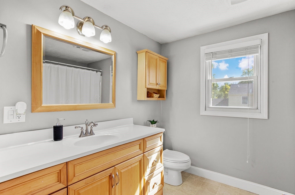 70 Underhill Street Nashua, NH 03060 - Photo 22 of 39 a bathroom with a toilet a sink a vanity and mirror
