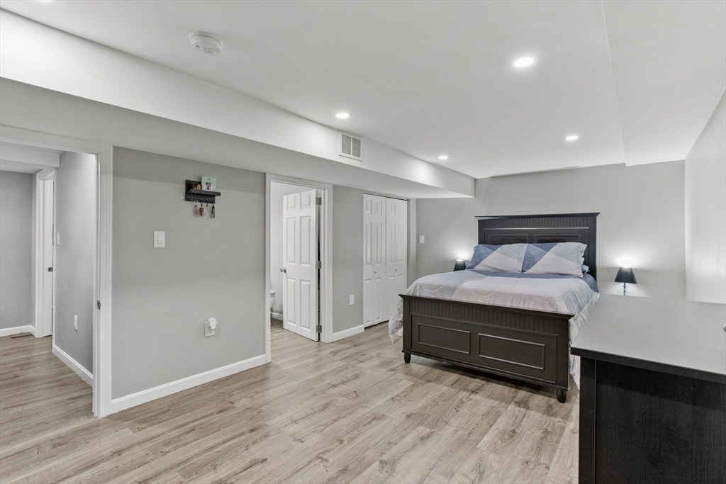 70 Underhill Street Nashua, NH 03060 - Photo 25 of 39 a bedroom with a bed and wooden floor