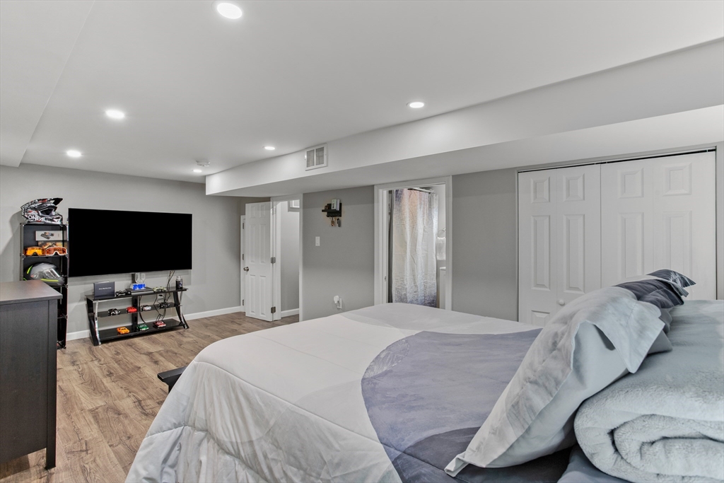 70 Underhill Street Nashua, NH 03060 - Photo 26 of 39 a bedroom with a bed and a flat screen tv