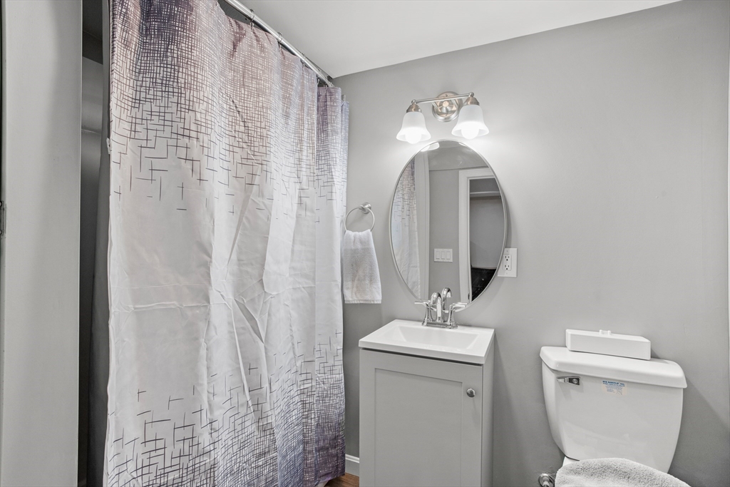 70 Underhill Street Nashua, NH 03060 - Photo 27 of 39 a bathroom with a toilet sink and mirror