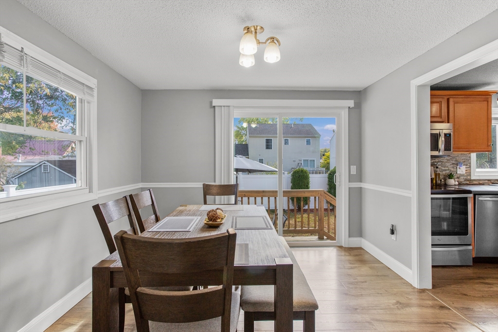 70 Underhill Street Nashua, NH 03060 - Photo 7 of 39 a view of a dining room with furniture large window and wooden floor