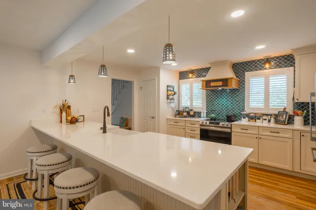a large kitchen with a table and chairs