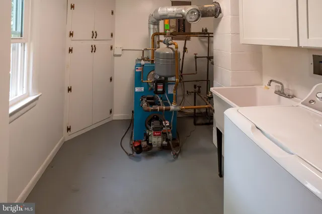 a view of storage and utility room with washing machine
