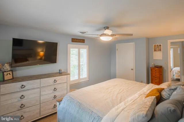 a bedroom with a large bed and a flat screen tv