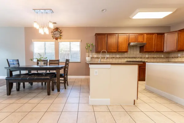 a kitchen with stainless steel appliances granite countertop a sink and a refrigerator
