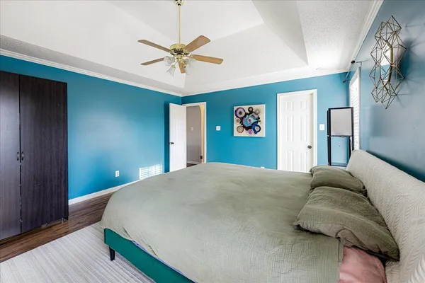 a bedroom with a bed and a chandelier