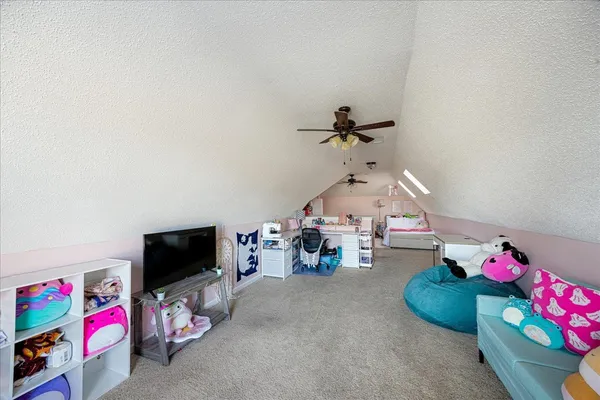 a view of a chair and table in backyard of the house