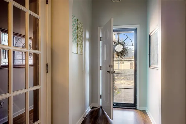 a view of an entryway with wooden floor