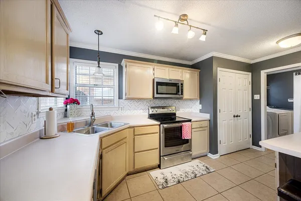 a kitchen with a sink stove and microwave