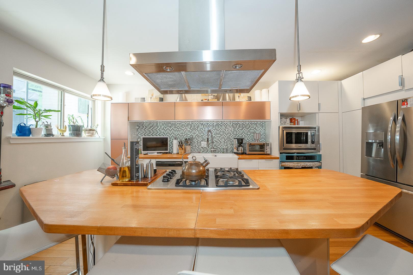 715 Shirley Street, Unit A Philadelphia, PA 19130 - Photo 11 of 24 a large kitchen with a table chairs and a wooden floor