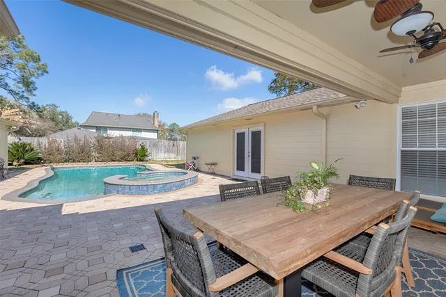 a view of a patio with a table and chairs and potted plants