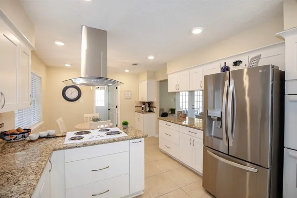 a kitchen with stainless steel appliances granite countertop a sink stove and refrigerator