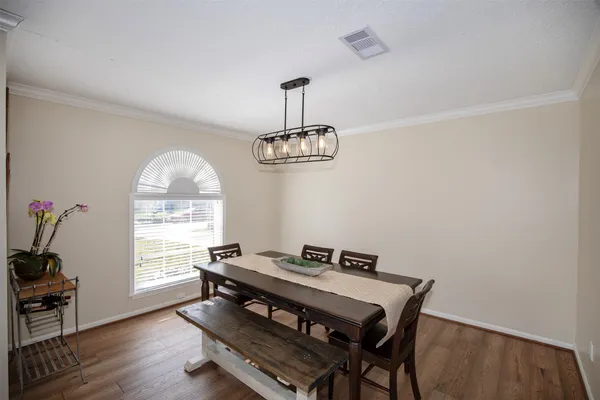 a view of a dining room with furniture window and wooden floor