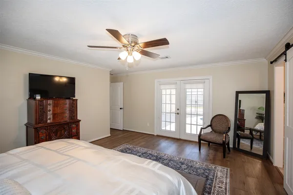 a bedroom with a bed and a chandelier
