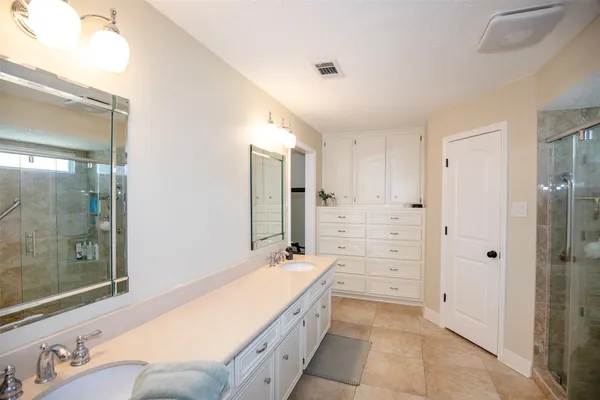 a living room with a bed furniture and a flat screen tv