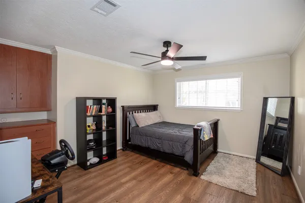 a bedroom with a bed and a bookshelf